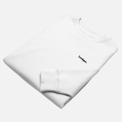 Folded white sweatshirt with 'Lumique' branding on a white background