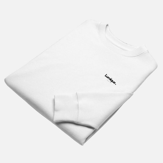 Folded white sweatshirt with 'Lumique' branding on a white background
